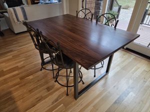 Custom solid walnut bar-height table on a modern steel base, built for a home in Minneapolis–St. Paul