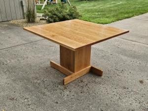 Cherry pedestal kitchen table with a cross-foot base, custom made in Minneapolis–St. Paul